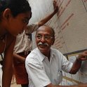 Sri P.S. Seshadri explaining about the stamps to a Patasala Vidyarthi